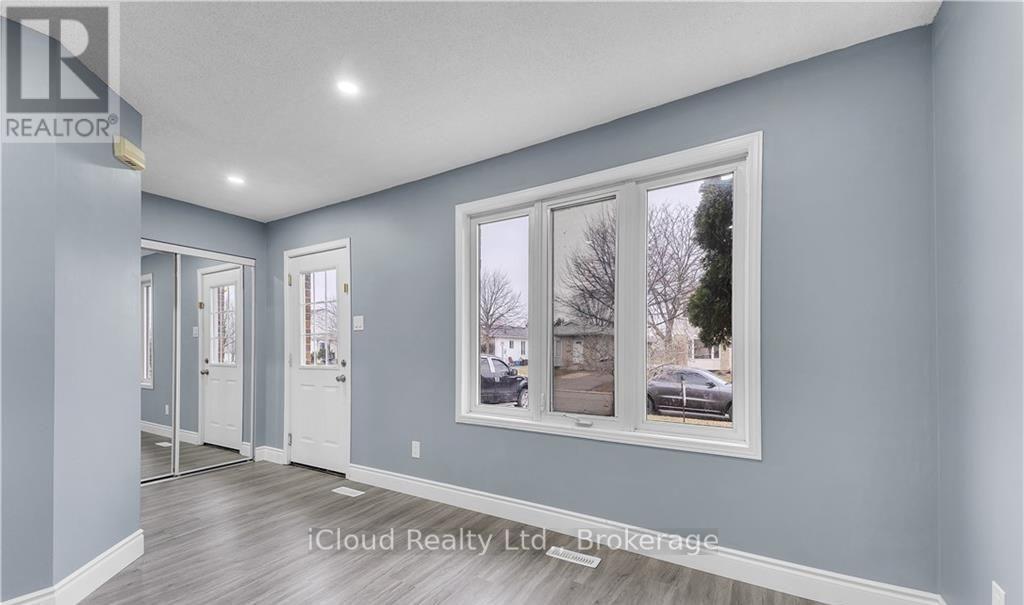 A realtor brokerage image of a room with a window showing an outdoor view.