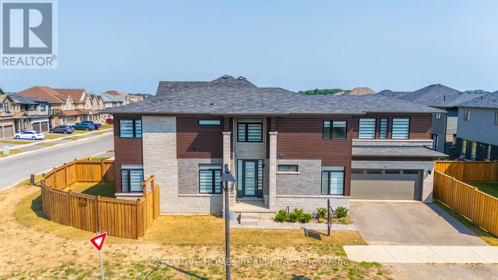 A house with a brown and grey exterior is for sale.