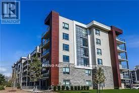 A modern multi-story building with a stone facade and balconies.