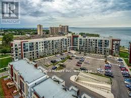 A large apartment complex with a parking lot in front.