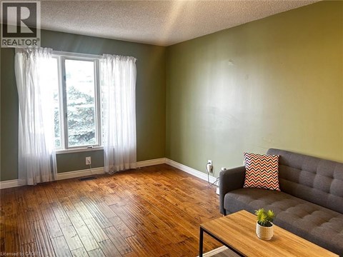 A living room with a grey couch and a wooden coffee table.