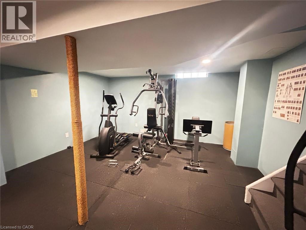 A gym room with a variety of exercise equipment.