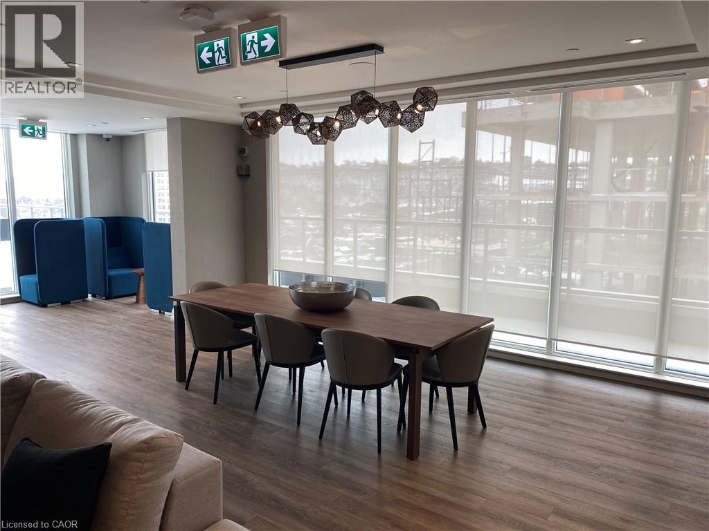 A conference room with a long table and chairs, a couch, and a chandelier.