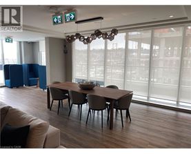 A conference room with a long table and chairs, a couch, and a chandelier.