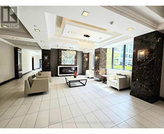 A spacious living room with a chandelier, a sofa set, and a coffee table.