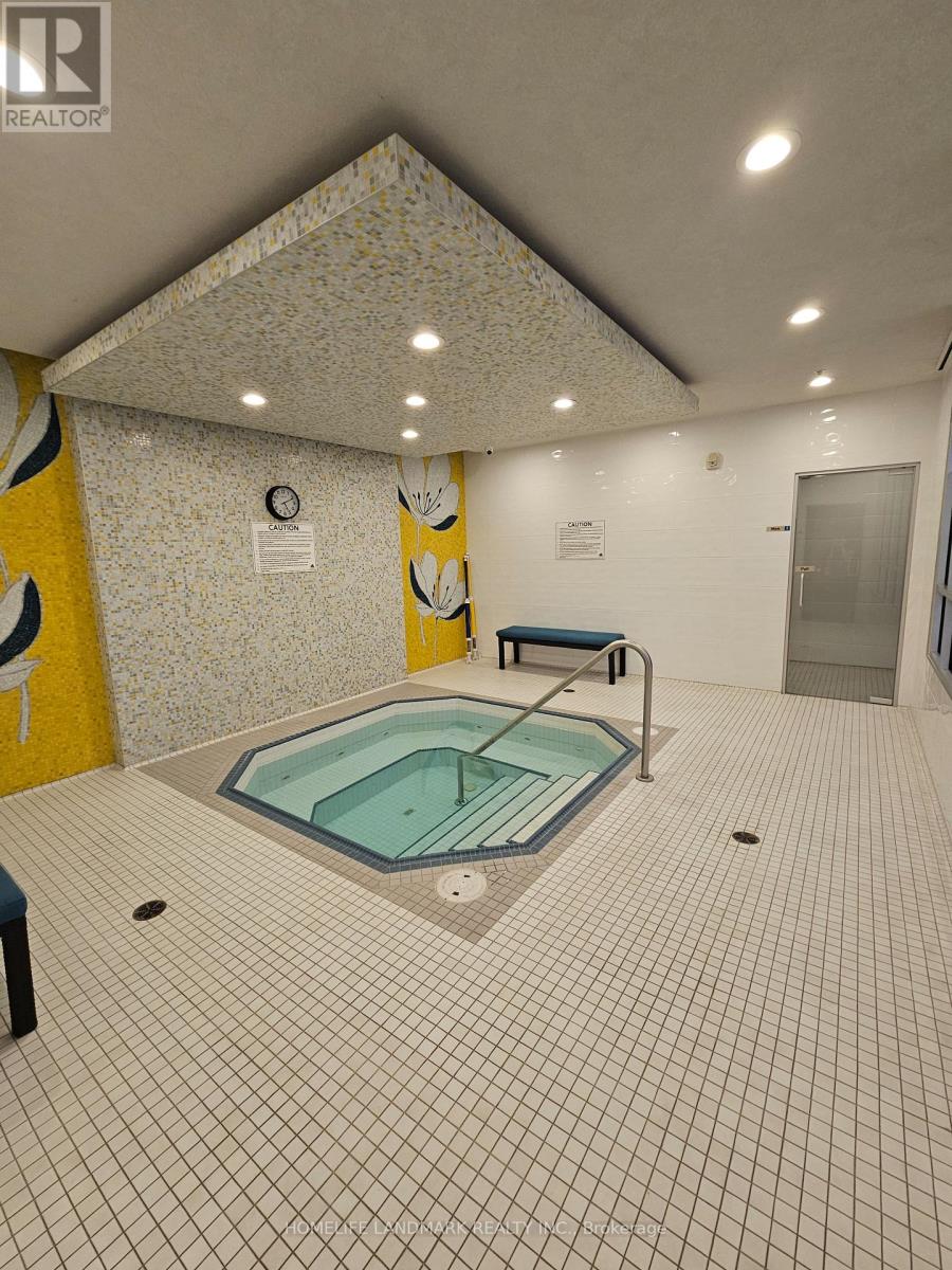 A small indoor pool with a bench.