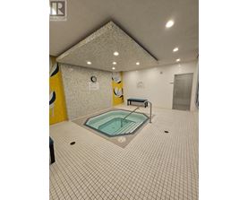 A small indoor pool with a bench.