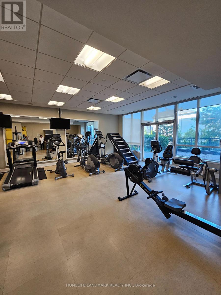 A gym with a variety of equipment including treadmills, weights, and exercise machines.