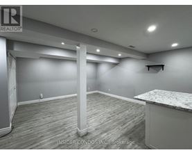 A spacious room with a marble countertop and wooden flooring.