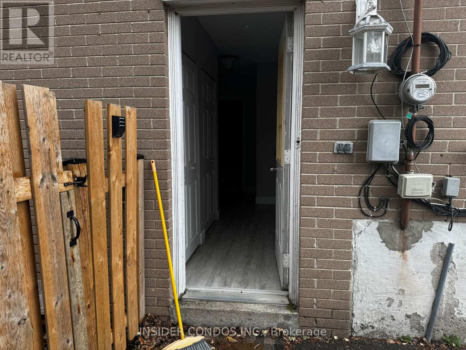 A doorway with a sign that says REALTOR on the wall.