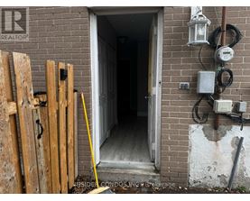 A doorway with a sign that says REALTOR on the wall.