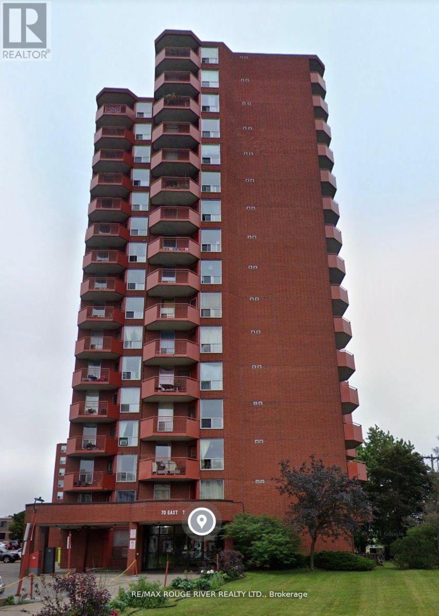A tall red building with balconies on the upper floors.