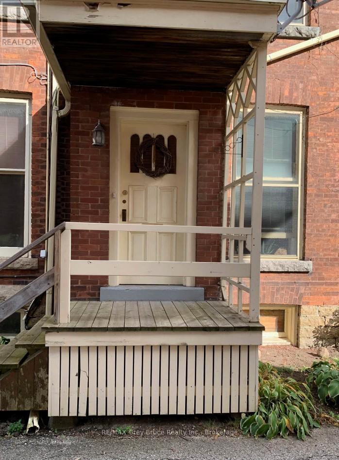 A house with a brown door and a porch.