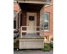 A house with a brown door and a porch.