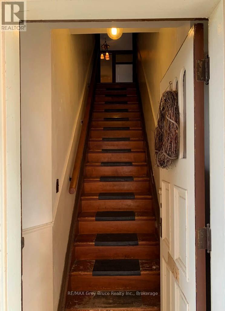 A staircase with a light on at the top.