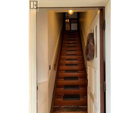 A staircase with a light on at the top.