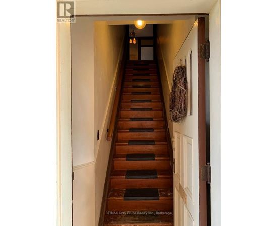 A staircase with a light on at the top.