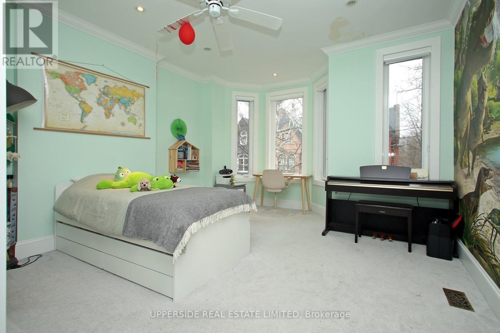 A bedroom with a bed, desk, and chair.