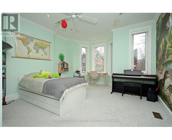 A bedroom with a bed, desk, and chair.