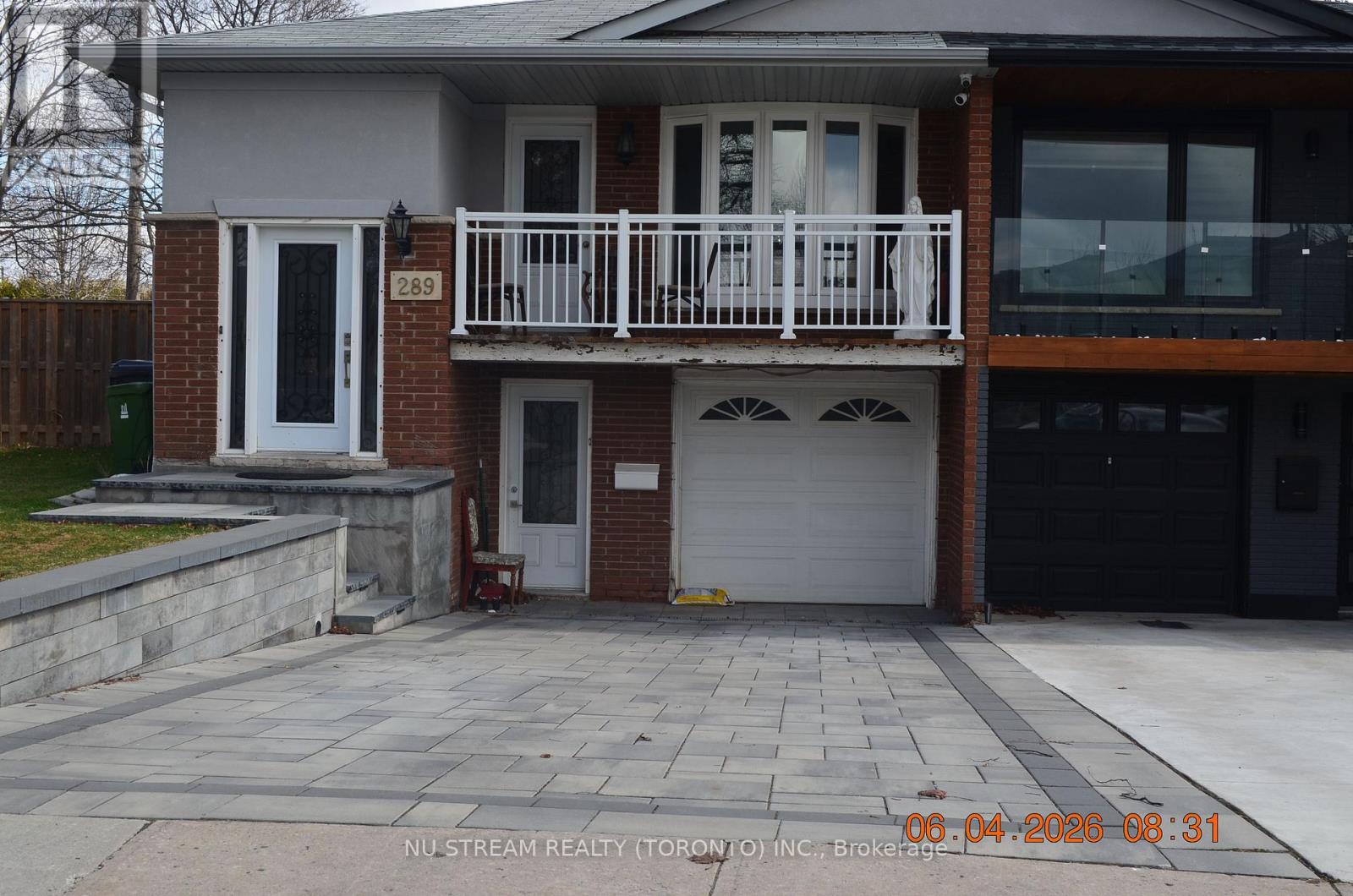 A house with a balcony and a garage is shown in the image.