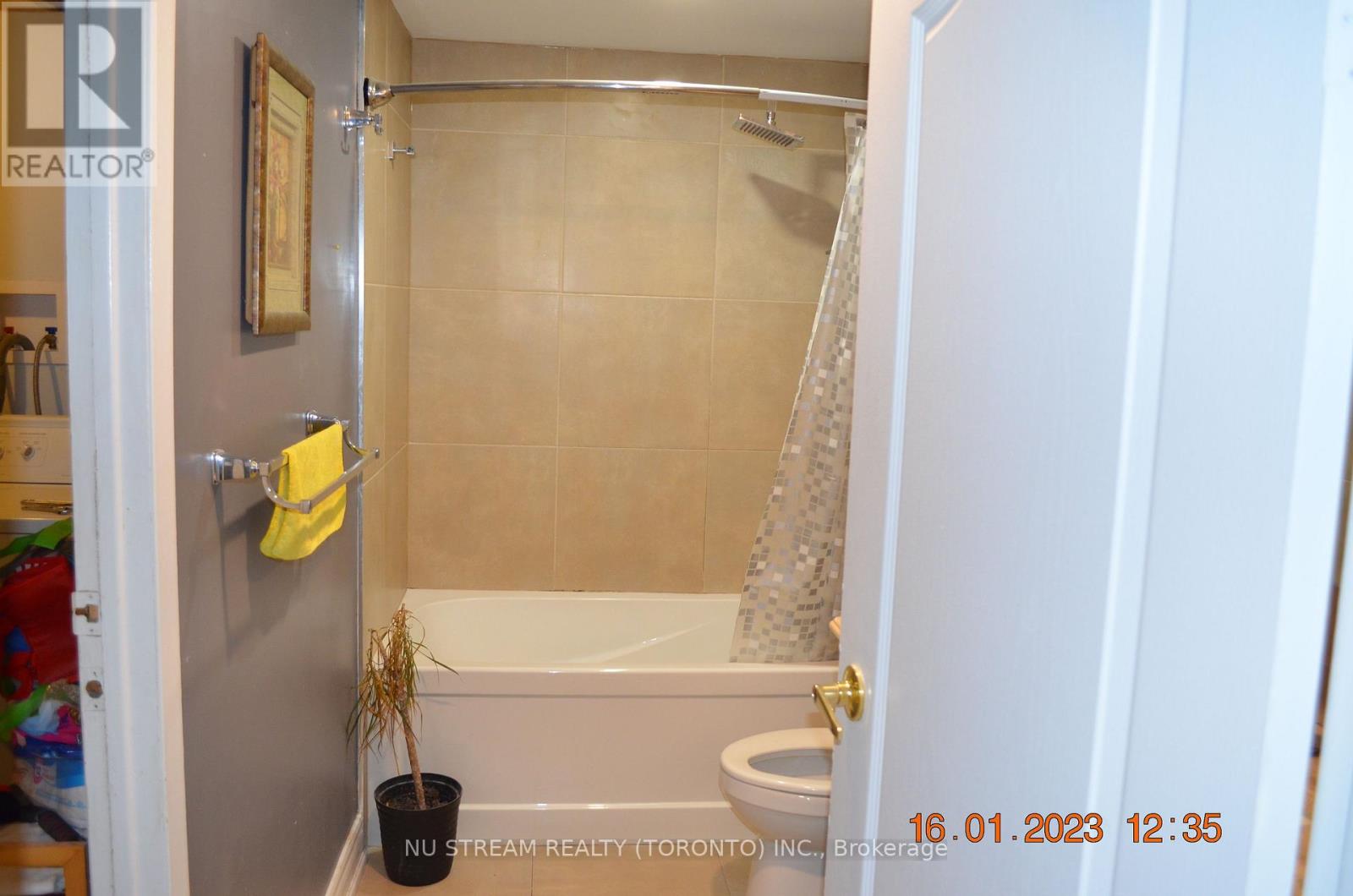 A bathroom with a toilet, tub, and shower.