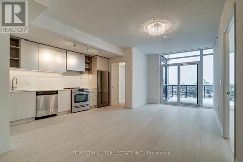 A spacious kitchen with white cabinets and stainless steel appliances.