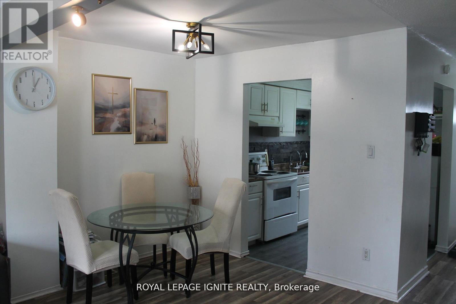 A dining room with a glass table and chairs.