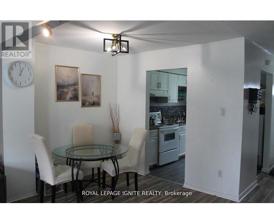 A dining room with a glass table and chairs.