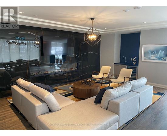 A modern living room with a large sectional sofa and a coffee table.