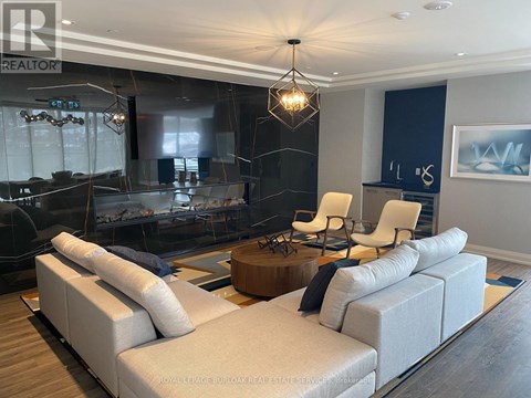 A modern living room with a large sectional sofa and a coffee table.