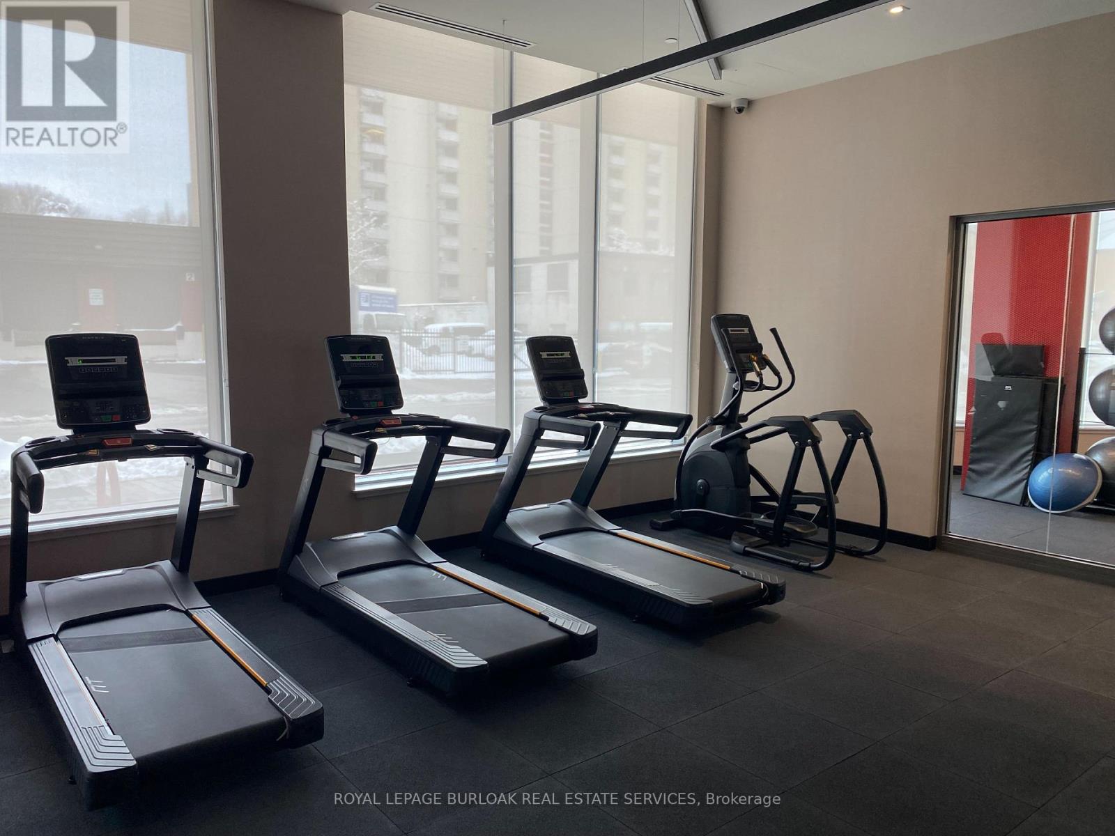 A gym with treadmills and exercise balls.