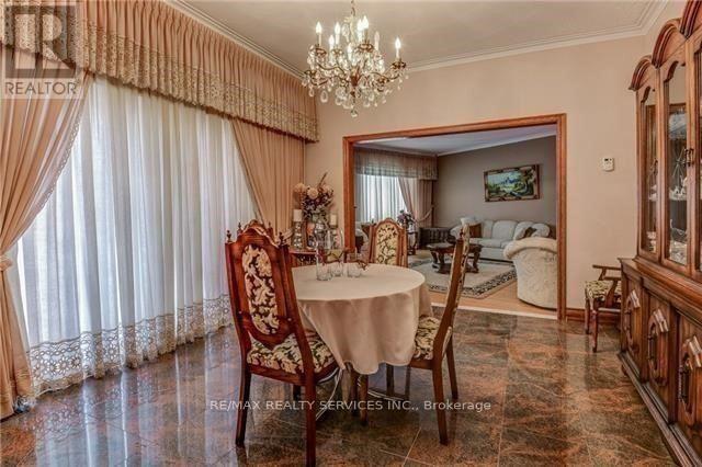 A dining room with a table set for two and a chandelier.