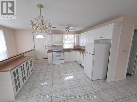 A kitchen with white cabinets and a chandelier.
