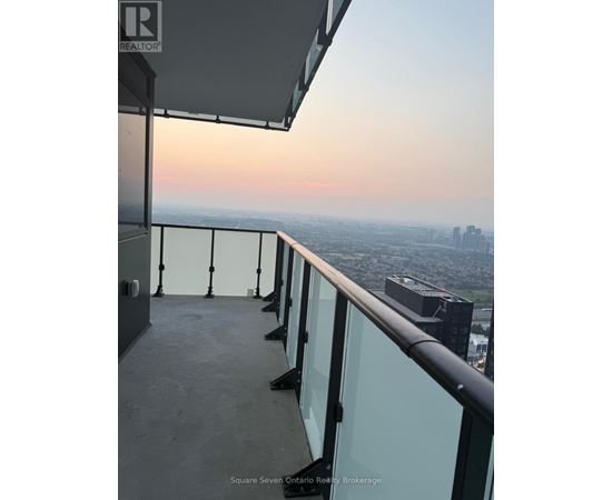 A balcony with a view of a cityscape at dusk.