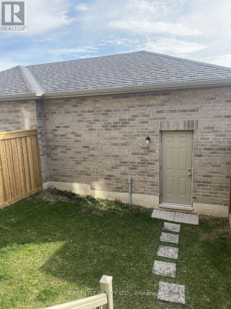A grey door is on a brick building.