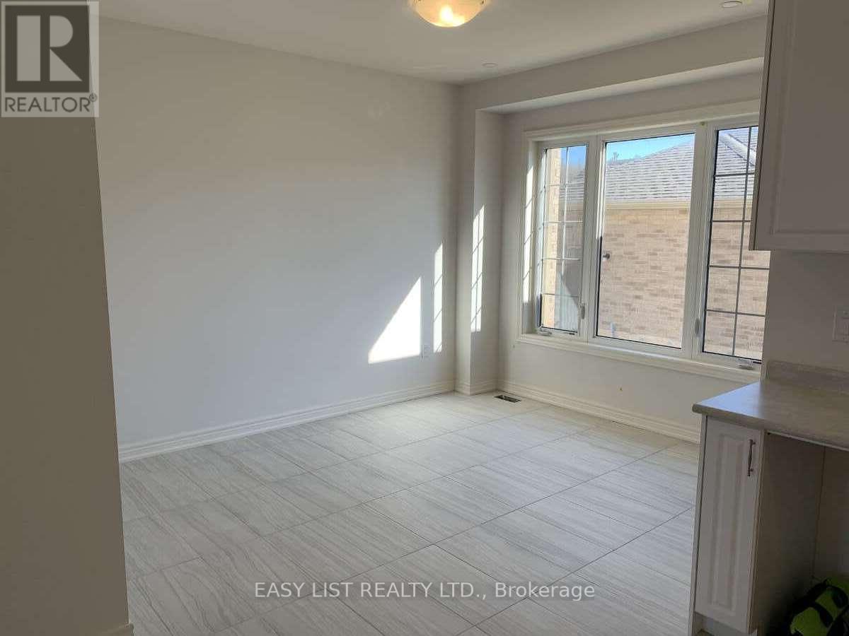 A room with a large window and a tiled floor.