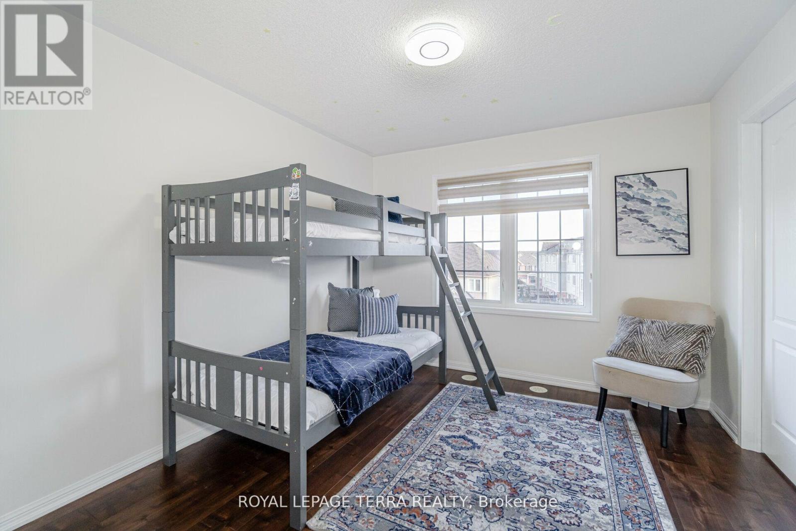A bedroom with a bunk bed and a bench.