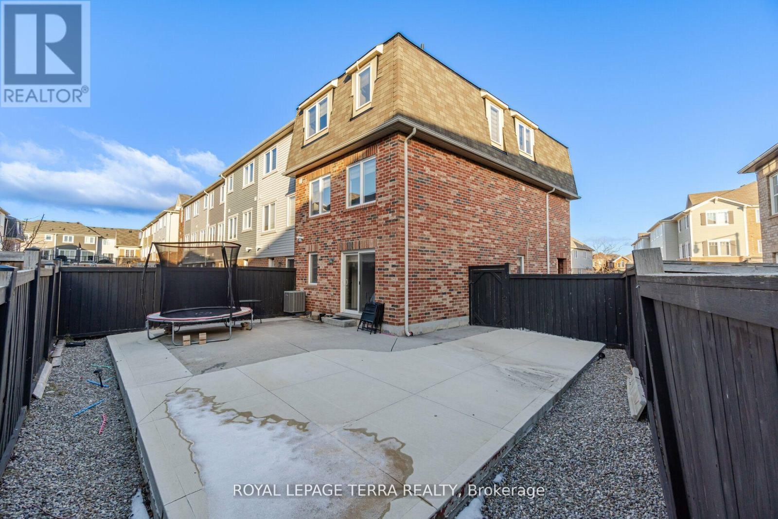 A house with a patio and a hot tub is for sale.