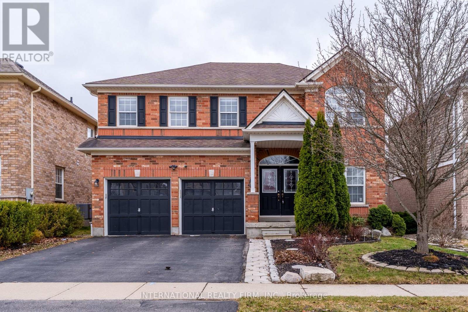 A brick house with a black garage door.