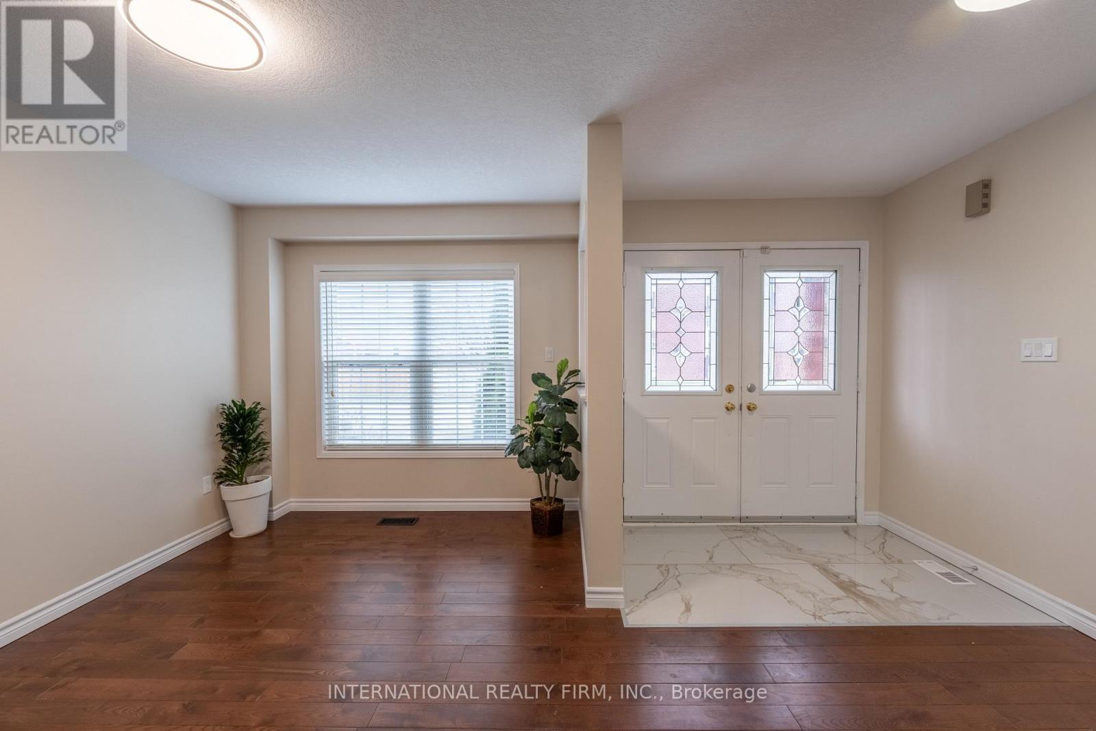 A room with a white door and a window with blinds.