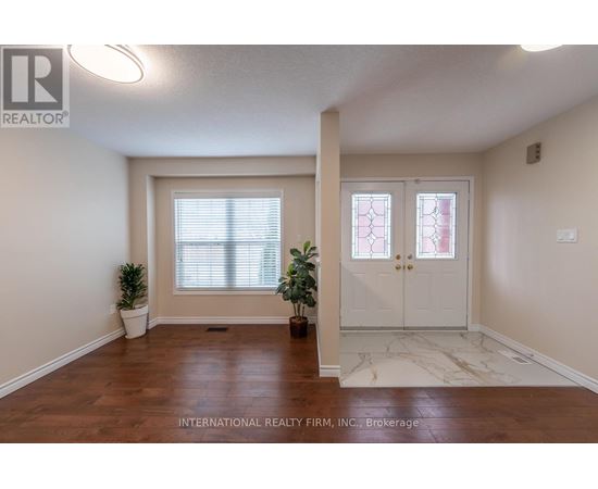 A room with a white door and a window with blinds.