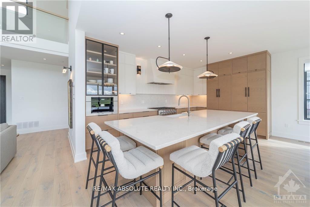 A modern dining room with a large table and chairs.