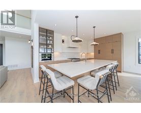 A modern dining room with a large table and chairs.