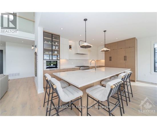 A modern dining room with a large table and chairs.
