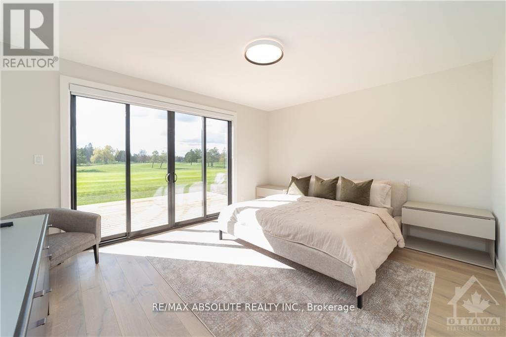 A bedroom with a large bed and sliding glass doors.