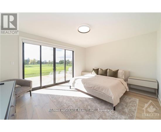 A bedroom with a large bed and sliding glass doors.
