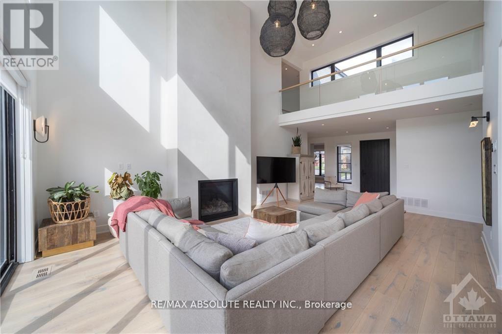 A modern living room with a grey sofa and a television.