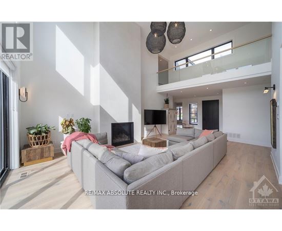 A modern living room with a grey sofa and a television.