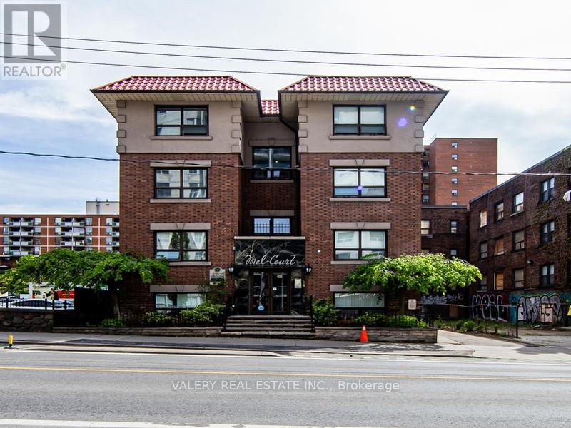 A building with a sign that says "Valery Real Estate Inc., Brokerage" in front of it.