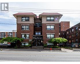 A building with a sign that says "Valery Real Estate Inc., Brokerage" in front of it.